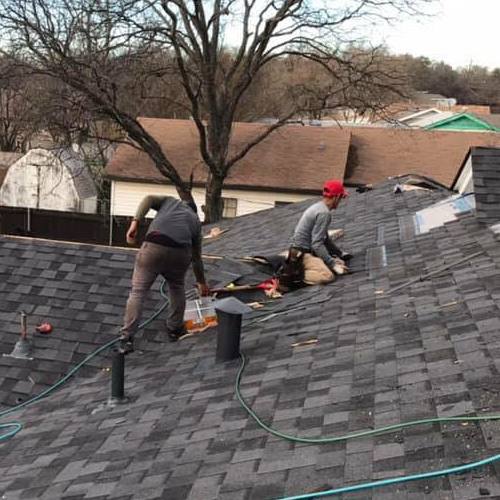 A roofer repairing shingles.