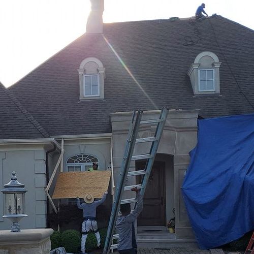 Roofer makes emergency roof repair.
