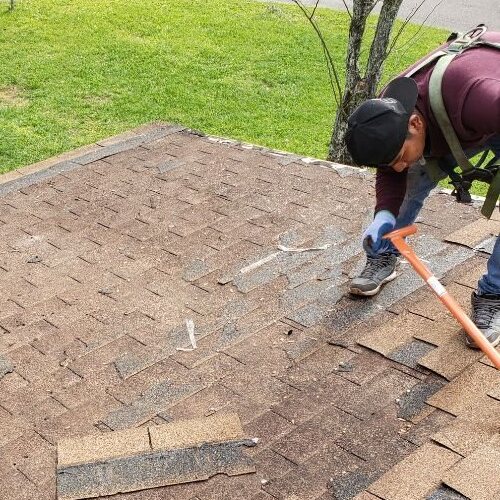 Roofer repairs hail damage