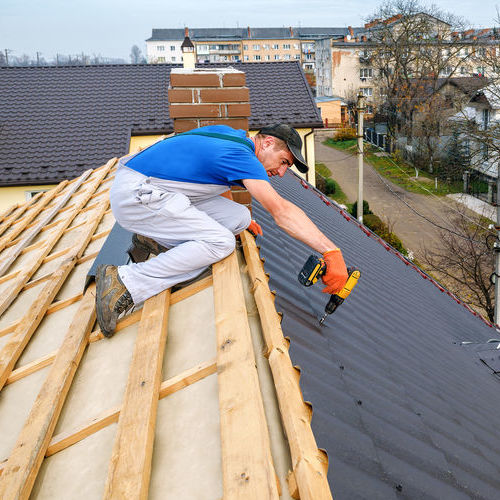Roofer works on roof installation.