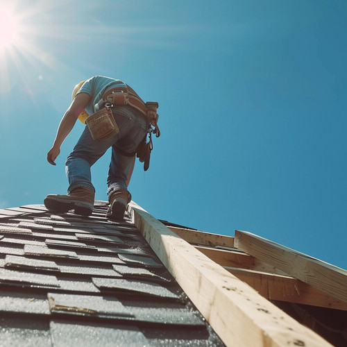 roofer on a shingle roof