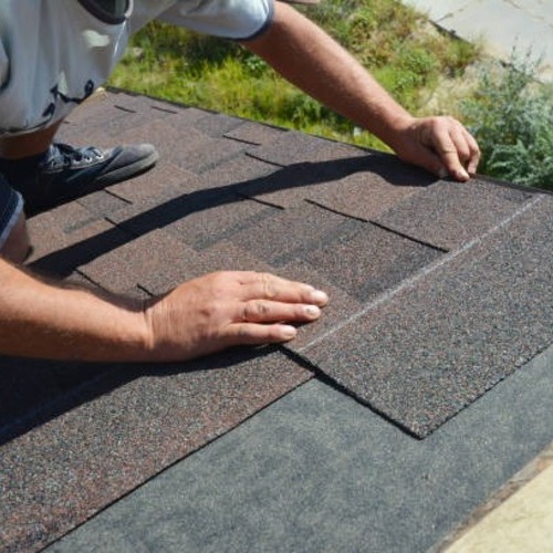 worker repairing a roofing leak